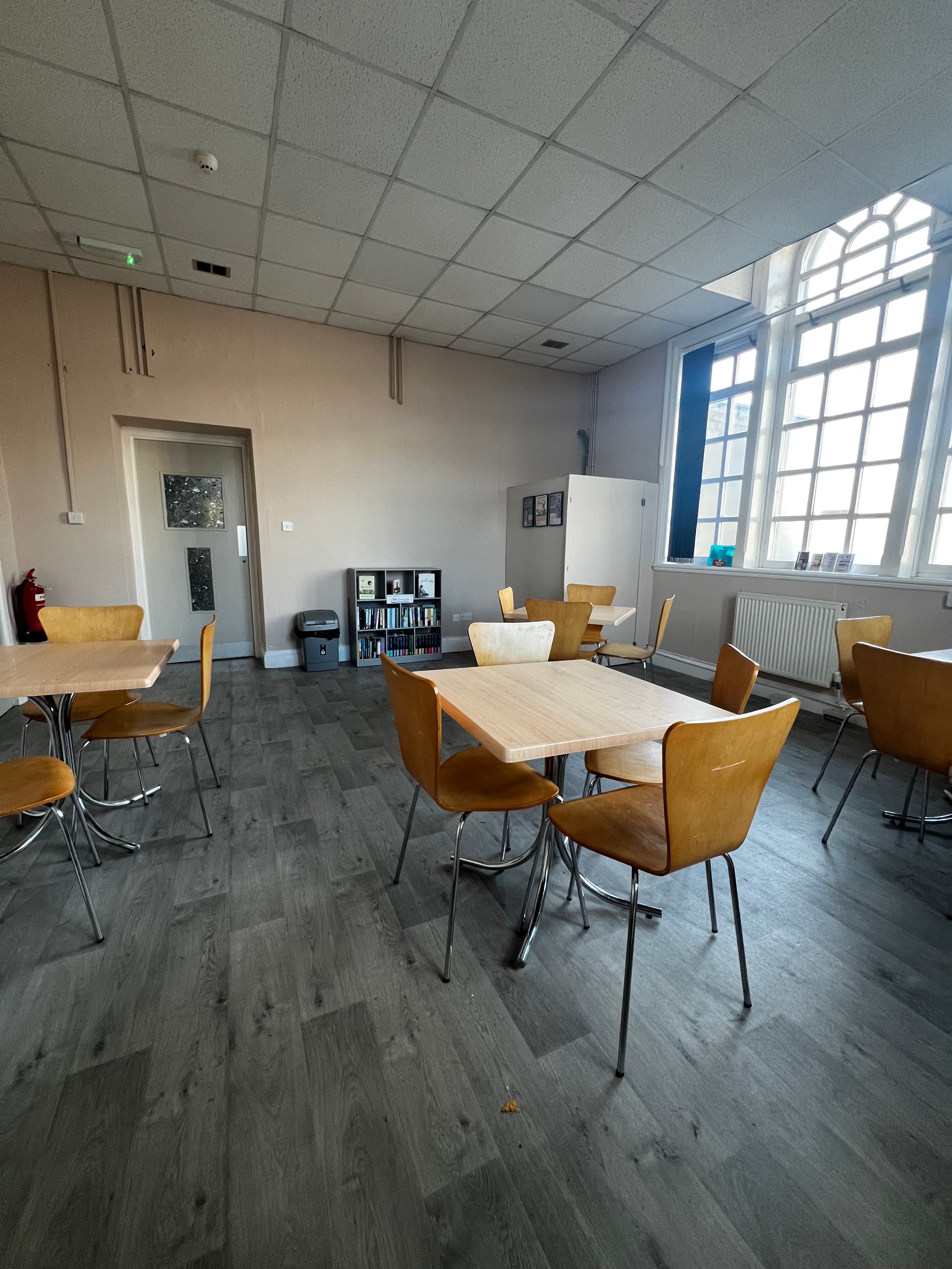 Seating area with tables and chairs at Crook Community Centre